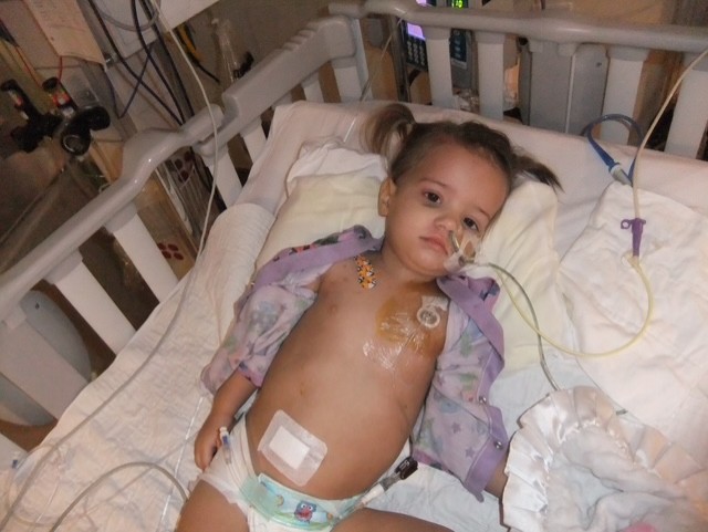 Anikah in her hospital bed recovering from brain surgery