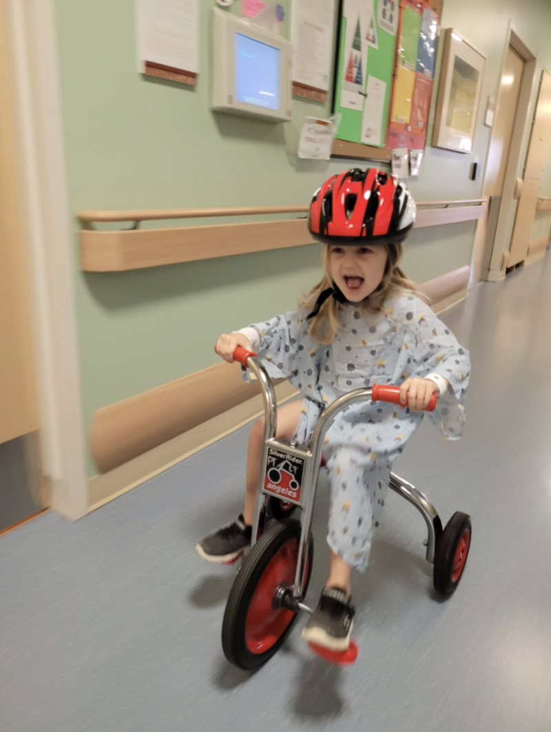 Ada riding a bike in the hospital hall