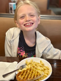 Ella smiling big at lunch