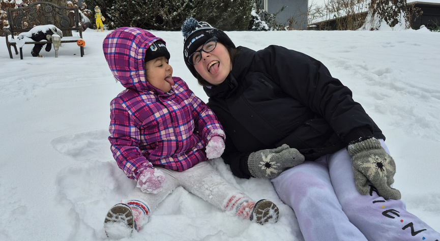Liz playing with her daughter in the snow
