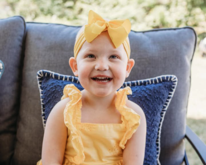 Charlotte posing for a picture on the couch