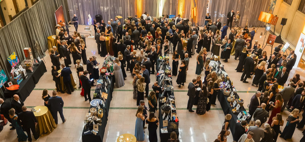 Crowd of people viewing auctioned items