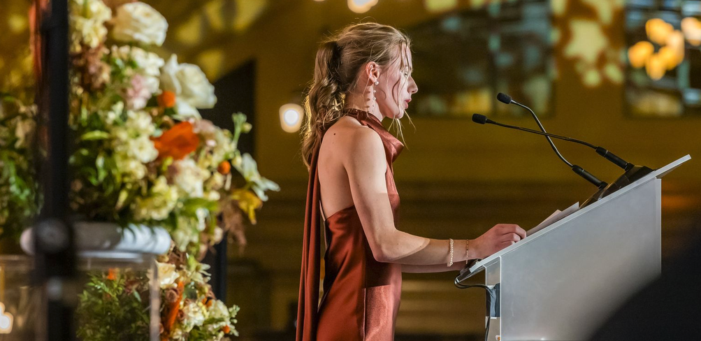 A presenter speaking at the podium 