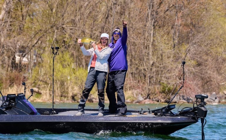 Randy and Kenna holding up a bass